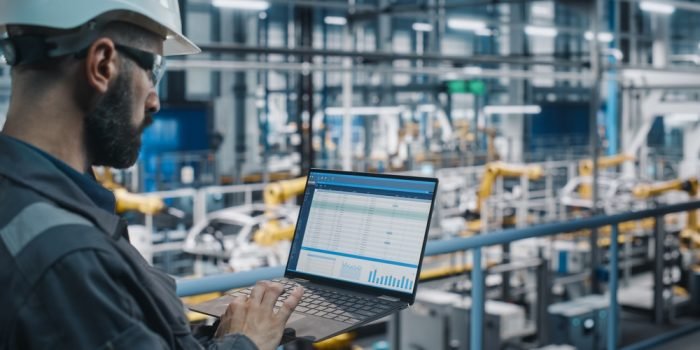 Car,Factory,Engineer,In,Work,Uniform,Using,Laptop,Computer,With